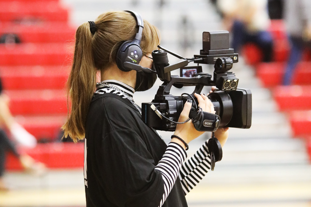 Female student holding video camera